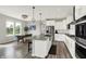 Bright, modern kitchen with an island and seating adjacent to an eat-in kitchen area and stainless steel appliances at 15717 Hush Hickory, Westfield, IN 46074
