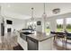 Bright open-concept kitchen featuring an island with stainless steel appliances and a granite countertop at 15717 Hush Hickory, Westfield, IN 46074