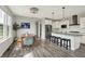 Open-concept kitchen featuring white cabinets, a stainless steel refrigerator, and an island with barstool seating at 15717 Hush Hickory, Westfield, IN 46074