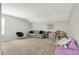 Neutral-toned living room with modern decor, plush carpet, and ample natural light perfect for a playroom at 15717 Hush Hickory, Westfield, IN 46074