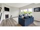 Bright and inviting living room featuring a fireplace, comfortable seating, and large windows offering outdoor views at 15717 Hush Hickory, Westfield, IN 46074
