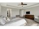 Large main bedroom with ensuite, modern ceiling fan, and cozy dresser for a comfortable retreat at 15717 Hush Hickory, Westfield, IN 46074