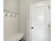 Entryway mudroom with bench seating, coat hooks, and a door that provides a convenient transition space at 15717 Hush Hickory, Westfield, IN 46074
