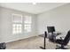 Office with window view: black desk, rolling chair, natural light, and neutral decor create a functional workspace at 15717 Hush Hickory, Westfield, IN 46074