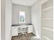 Bright office with white cabinets, a black countertop, a comfortable chair, and views from a natural light window at 15717 Hush Hickory, Westfield, IN 46074