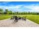 Stamped concrete patio with four chairs around a fire pit, perfect for enjoying outdoor evenings in the backyard at 15717 Hush Hickory, Westfield, IN 46074