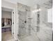 Spa-like marble shower with glass enclosure and a convenient bench, leading to a walk-in closet at 15717 Hush Hickory, Westfield, IN 46074