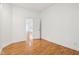 Neutral bedroom features hardwood floors and a door leading to the living area at 1804 Spann Ave, Indianapolis, IN 46203