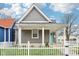 Charming gray home with white picket fence and inviting front porch in a quaint neighborhood setting at 1804 Spann Ave, Indianapolis, IN 46203