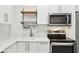 Modern kitchen featuring white countertops, stainless steel appliances, and white subway tile backsplash at 1804 Spann Ave, Indianapolis, IN 46203