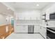 Modern kitchen with stainless steel appliances, white cabinets, and plenty of countertop space at 1804 Spann Ave, Indianapolis, IN 46203