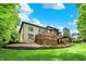 A spacious backyard featuring a large deck, patio, and meticulously designed landscaping at 1860 Red Fox E Ct, Martinsville, IN 46151