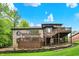Gorgeous brick home with a large deck, pergola, and beautiful landscaping at 1860 Red Fox E Ct, Martinsville, IN 46151