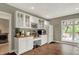 This bar area features white cabinets with glass fronts, a wine rack, and a beverage refrigerator, perfect for entertaining at 1860 Red Fox E Ct, Martinsville, IN 46151