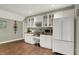 Basement bar area with white cabinets, wine rack, and microwave at 1860 Red Fox E Ct, Martinsville, IN 46151