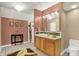 Bathroom featuring decorative mirror and lighting, tile accents, and earth tone decor at 1860 Red Fox E Ct, Martinsville, IN 46151