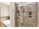 Elegant bathroom with tiled walk-in shower, soaking tub with tile surround, and modern fixtures at 1860 Red Fox E Ct, Martinsville, IN 46151