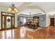 Spacious dining room with hardwood floors, chandelier, and glass-paneled entry door at 1860 Red Fox E Ct, Martinsville, IN 46151