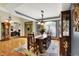Bright dining room with hardwood floors, an ornate light fixture, and an adjacent room with a home office at 1860 Red Fox E Ct, Martinsville, IN 46151