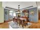Elegant dining room with hardwood floors, stylish chandelier, and display cabinet at 1860 Red Fox E Ct, Martinsville, IN 46151