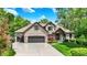Beautiful two-story brick home with a three-car garage, lush landscaping, and well-manicured lawn at 1860 Red Fox E Ct, Martinsville, IN 46151