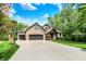 Charming brick home boasts a three-car garage and well-manicured lawn at 1860 Red Fox E Ct, Martinsville, IN 46151