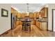 Spacious kitchen with hardwood floors, custom wood cabinetry, stainless steel appliances, and a center island at 1860 Red Fox E Ct, Martinsville, IN 46151