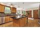 Kitchen with stainless steel appliances, wood cabinets, tile backsplash, a window with plantation shutters, and hardwood floors at 1860 Red Fox E Ct, Martinsville, IN 46151