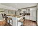 Basement kitchenette boasts white cabinets, a refrigerator, and barstool seating for casual dining at 1860 Red Fox E Ct, Martinsville, IN 46151