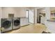 Laundry room featuring modern washer and dryer units, cabinets and shelving at 1860 Red Fox E Ct, Martinsville, IN 46151