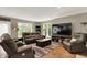 Comfortable living room with leather furniture and large TV creates an inviting space for relaxation and entertainment at 1860 Red Fox E Ct, Martinsville, IN 46151