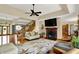 Comfortable living room with a fireplace, large windows, and a flat screen TV at 1860 Red Fox E Ct, Martinsville, IN 46151
