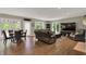 Open living room with hard wood floors, views to the outside, large tv, and cozy fireplace at 1860 Red Fox E Ct, Martinsville, IN 46151