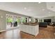 Open living room with large windows offering plenty of natural light and wood flooring at 1860 Red Fox E Ct, Martinsville, IN 46151