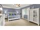 Main bedroom featuring white furniture, a ceiling fan, and large windows at 1860 Red Fox E Ct, Martinsville, IN 46151