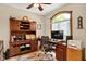 Home office with built-in wooden shelves, hardwood floors, and a large window with natural light at 1860 Red Fox E Ct, Martinsville, IN 46151