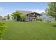 Expansive backyard featuring a covered grill and seating area with a fire pit, set against a lush green lawn at 18630 Goldwater Rd, Westfield, IN 46062