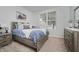 Bright bedroom with a large window, comfortable bed, and stylish gray wood furnishings at 18630 Goldwater Rd, Westfield, IN 46062