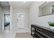 Bright entryway with neutral walls, a console table, a gold mirror, and tile flooring at 18630 Goldwater Rd, Westfield, IN 46062