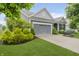 Charming home featuring a gray two-car garage, blue siding, and a well-manicured green lawn at 18630 Goldwater Rd, Westfield, IN 46062
