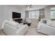 Bright living room features white sofas, a large window, and a ceiling fan at 18630 Goldwater Rd, Westfield, IN 46062