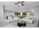 Open-concept living room with white sofas, a ceiling fan, and views of the kitchen at 18630 Goldwater Rd, Westfield, IN 46062