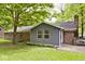 A well-maintained backyard showcases a home's exterior, blending brick and gray siding, complemented by lush greenery at 19446 Ethan Allen Ln, Westfield, IN 46074