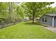 A sprawling backyard with fencing and a tree creates an inviting outdoor space with potential for recreation and relaxation at 19446 Ethan Allen Ln, Westfield, IN 46074