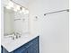 This bathroom features a quartz countertop vanity with stylish fixtures and a large mirror with lighting at 19446 Ethan Allen Ln, Westfield, IN 46074