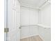 Walk-in closet with white wire shelving and light wood-look floor provides tidy storage solutions at 19446 Ethan Allen Ln, Westfield, IN 46074