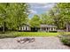 Charming front yard featuring a fire pit area and lovely home with manicured landscaping and mature trees at 19446 Ethan Allen Ln, Westfield, IN 46074