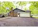 Back exterior showing a brick and siding house with an attached garage, basketball hoop, and paved driveway at 19446 Ethan Allen Ln, Westfield, IN 46074