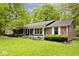 Well-maintained front yard featuring a brick and siding home with manicured landscaping and mature trees at 19446 Ethan Allen Ln, Westfield, IN 46074