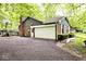 Exterior angle highlighting the brick and siding of the garage with a basketball hoop and paved driveway at 19446 Ethan Allen Ln, Westfield, IN 46074